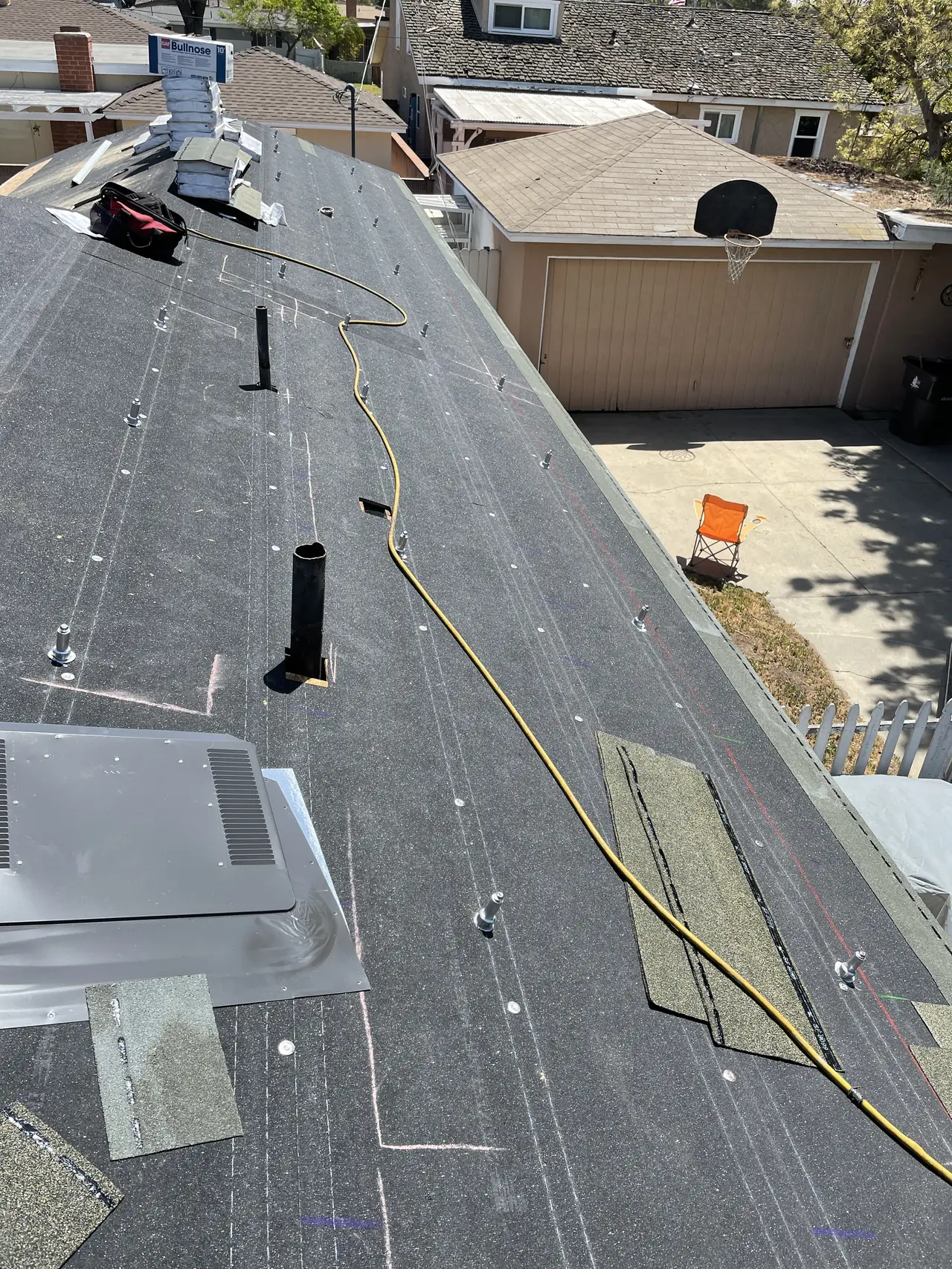 New shingle courses starting to go down beside the mounting feet on an open roof deck, Long Beach