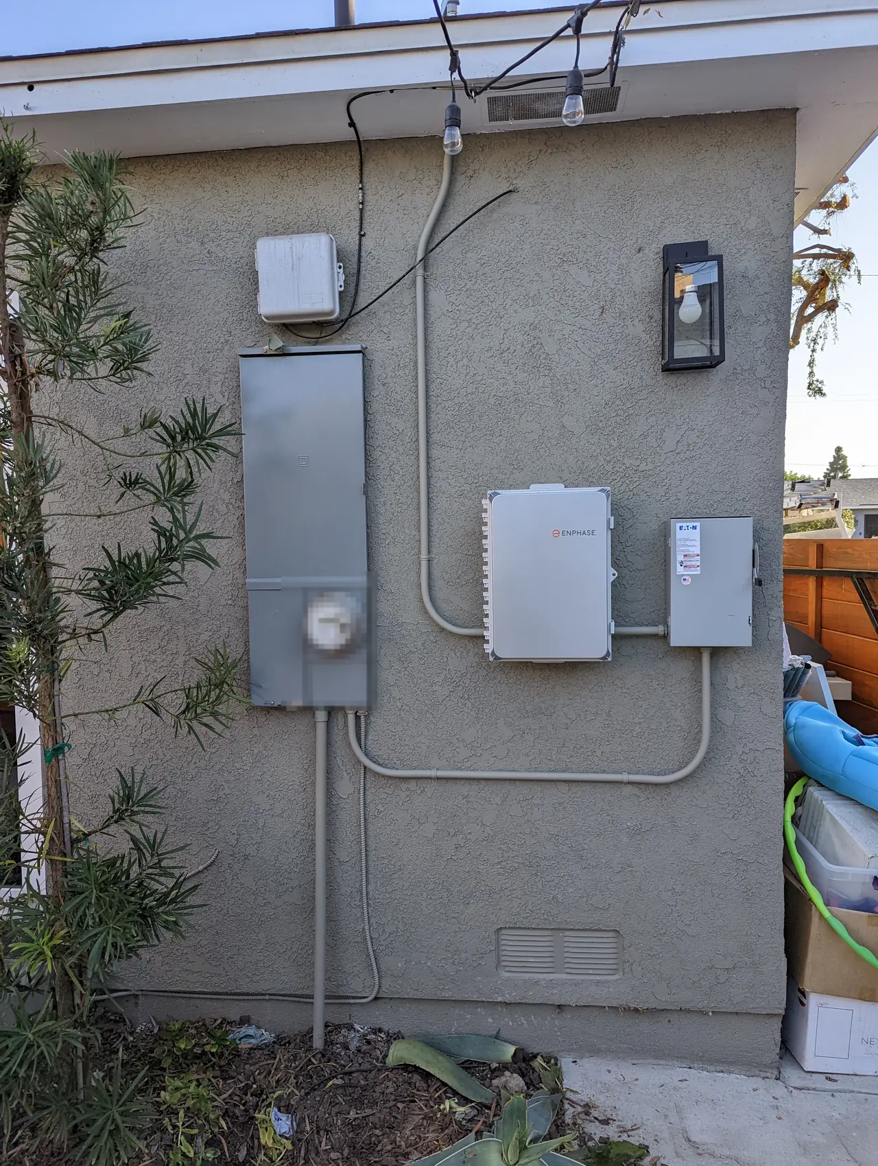 A run of service enclosures and disconnects mounted along a stucco wall, Long Beach