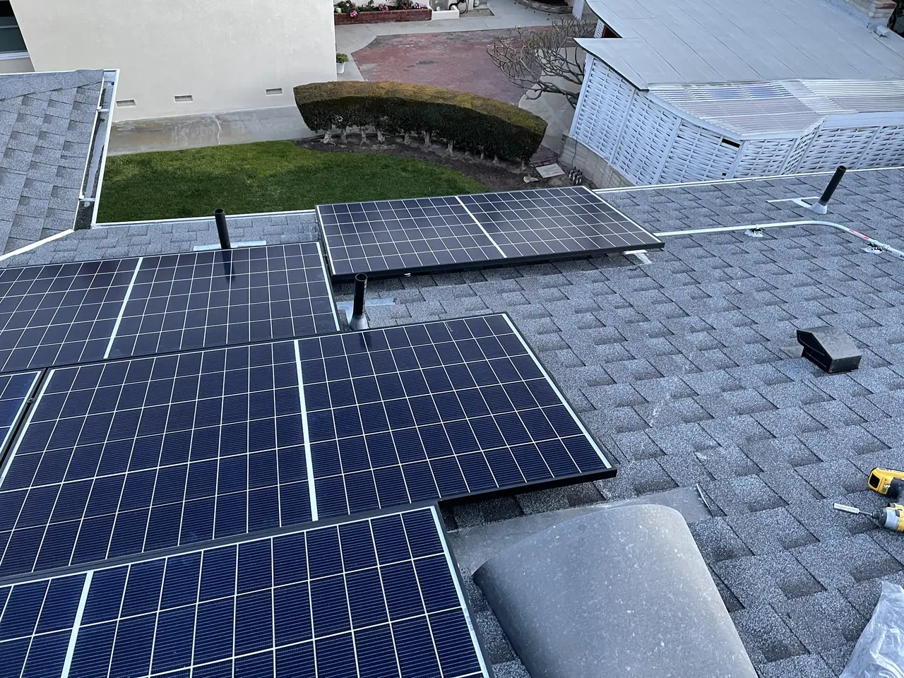 Solar modules on a shingle roof against open sky, Westchester, Los Angeles