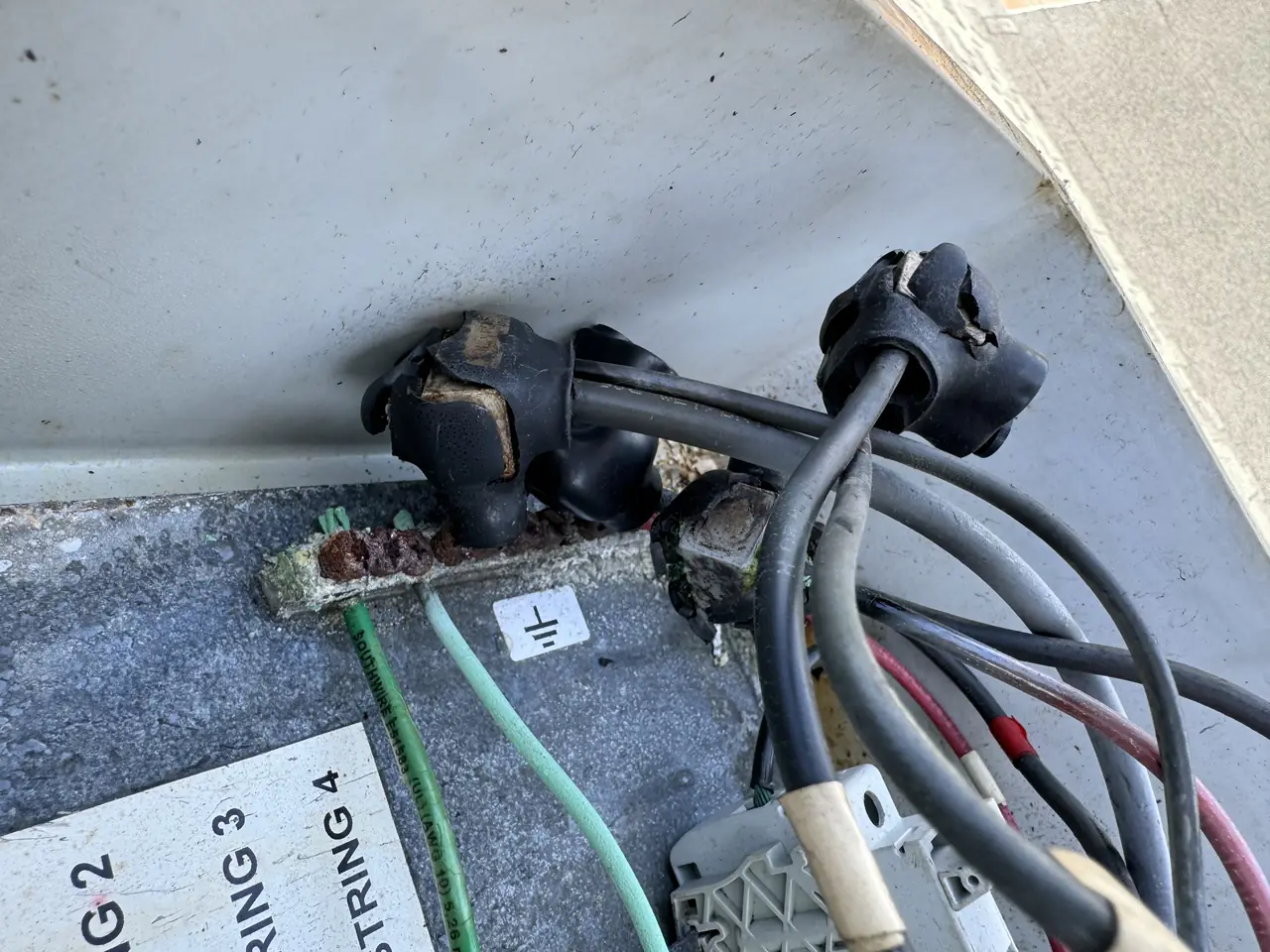 Burned cable glands and scorched insulation where the strings enter a rooftop combiner box, Windsor Square, Los Angeles