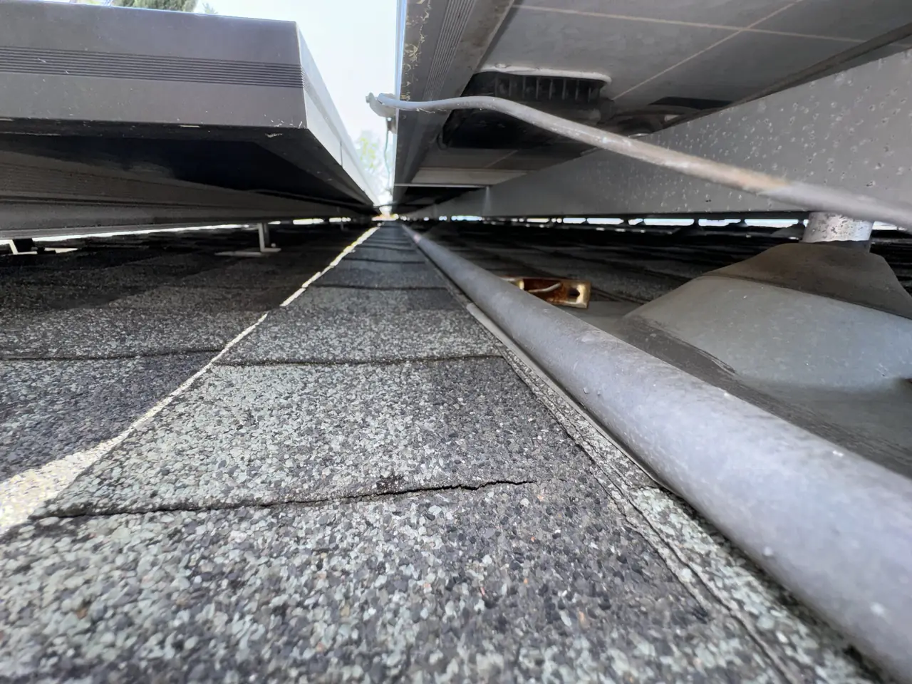 Cable run along a mounting rail beneath solar modules, Windsor Square, Los Angeles