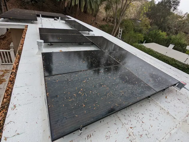 Black solar modules on a newly replaced white low-slope roof, Glassell Park, Los Angeles