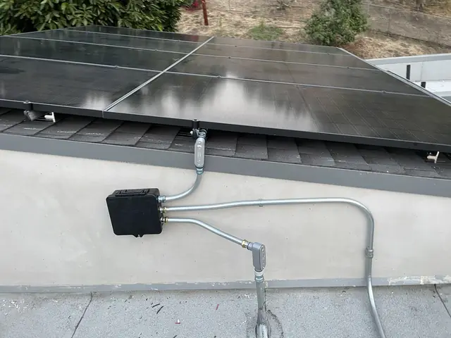 Solar panel mounting detail on a composition shingle roof in Los Angeles, CA