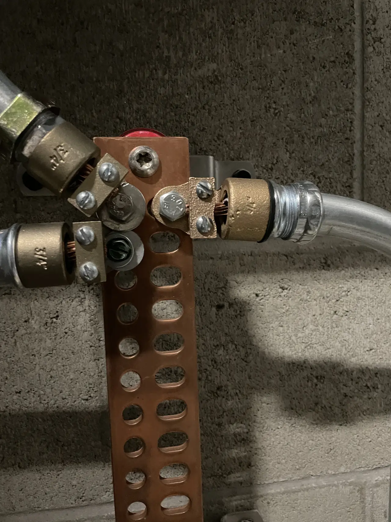 A copper grounding bar with bonded conductors landed on it, Palms, Los Angeles