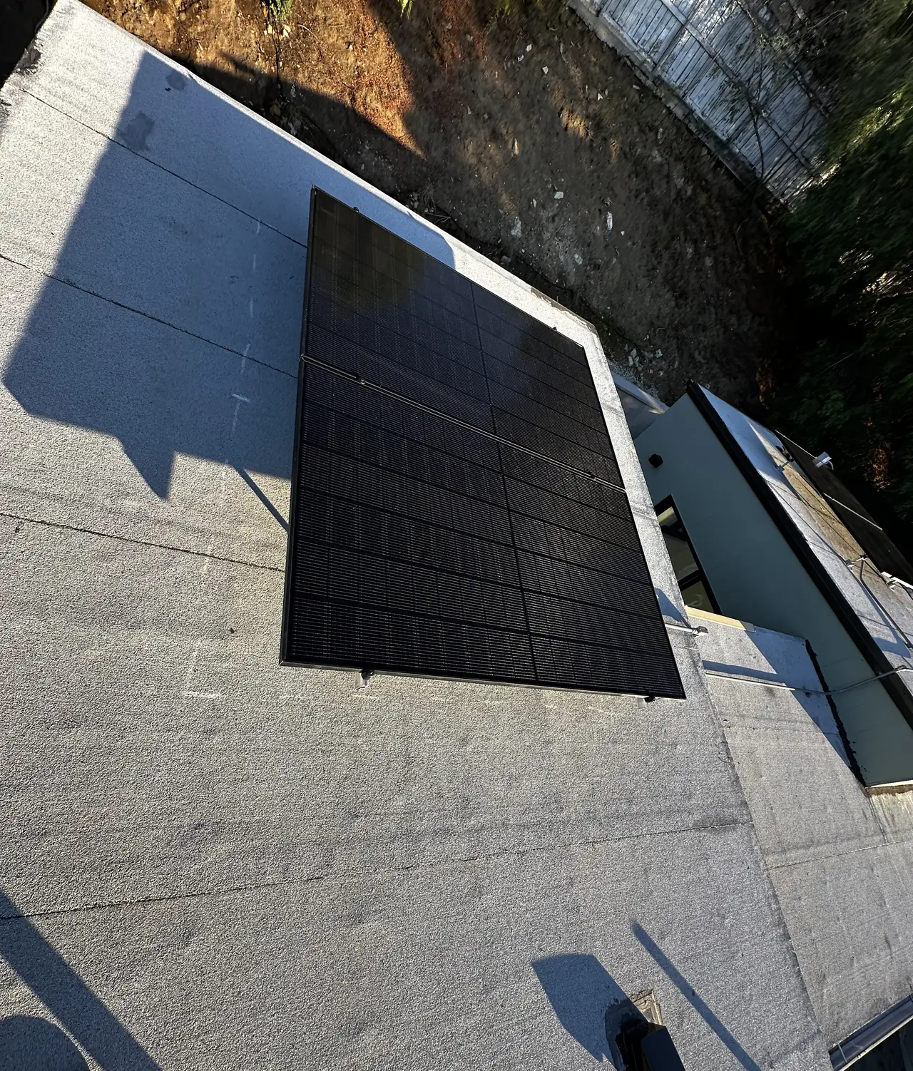 A single solar module on a flat roof membrane, Echo Park, Los Angeles