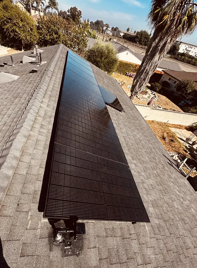 A solar array on a composition shingle roof seen from above, South Los Angeles