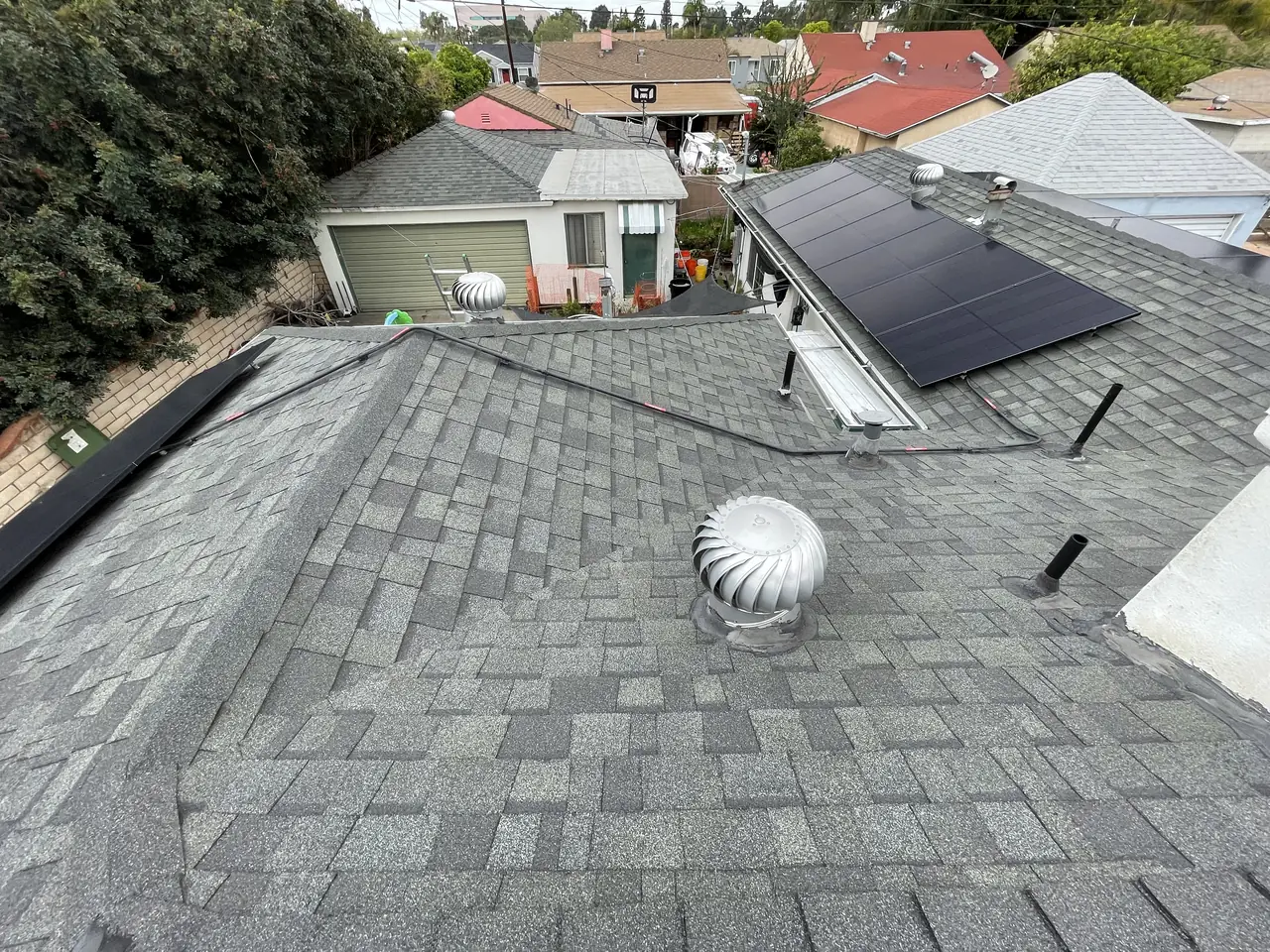 Modules and a roof vent on a shingle roof, East Los Angeles