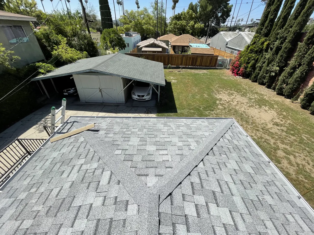 A composition shingle roof before the array, with the neighborhood beyond, Eagle Rock, Los Angeles