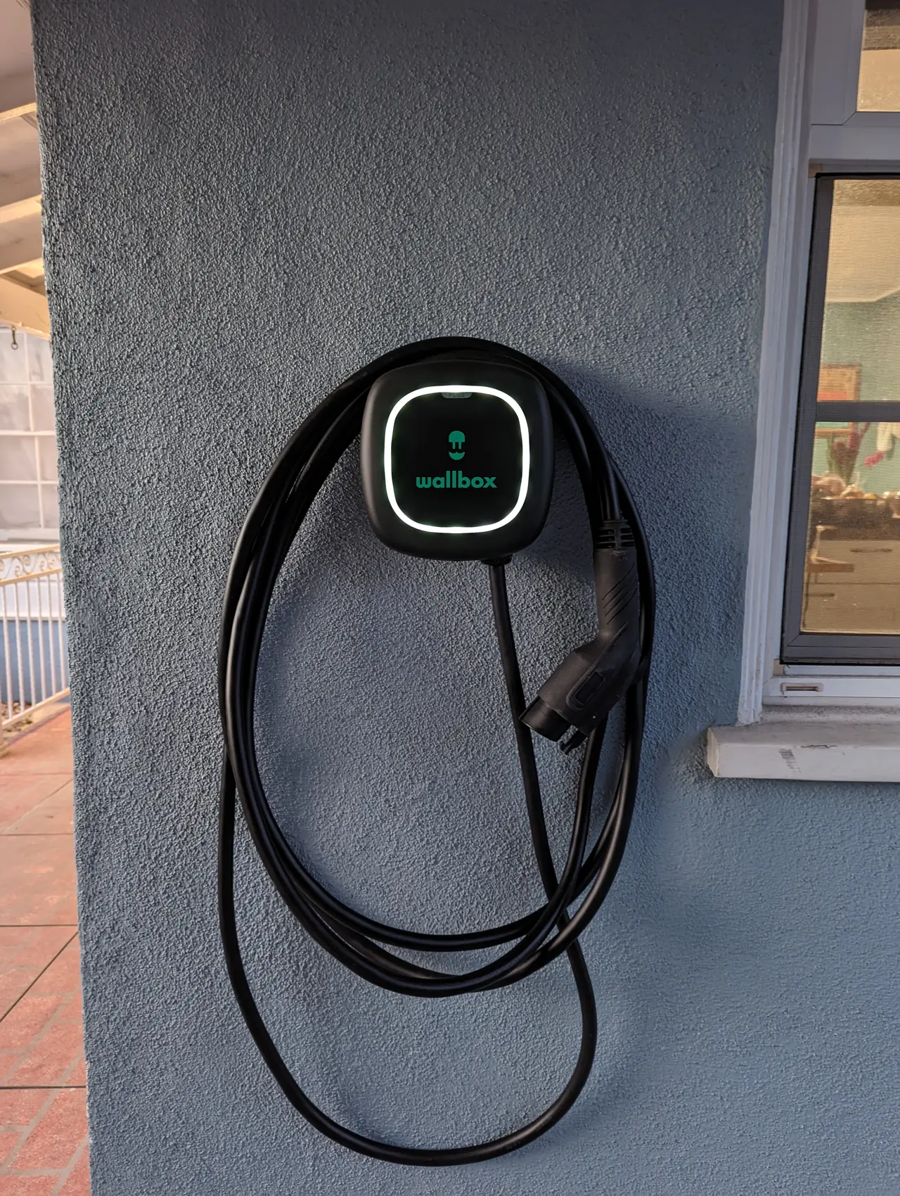 A level 2 electric vehicle charger mounted on an exterior wall, Westchester, Los Angeles