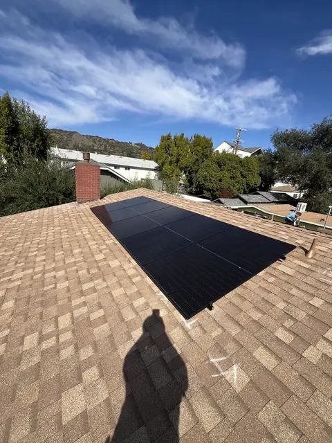 Solar panel mounting detail on a composition shingle roof in Los Angeles, CA