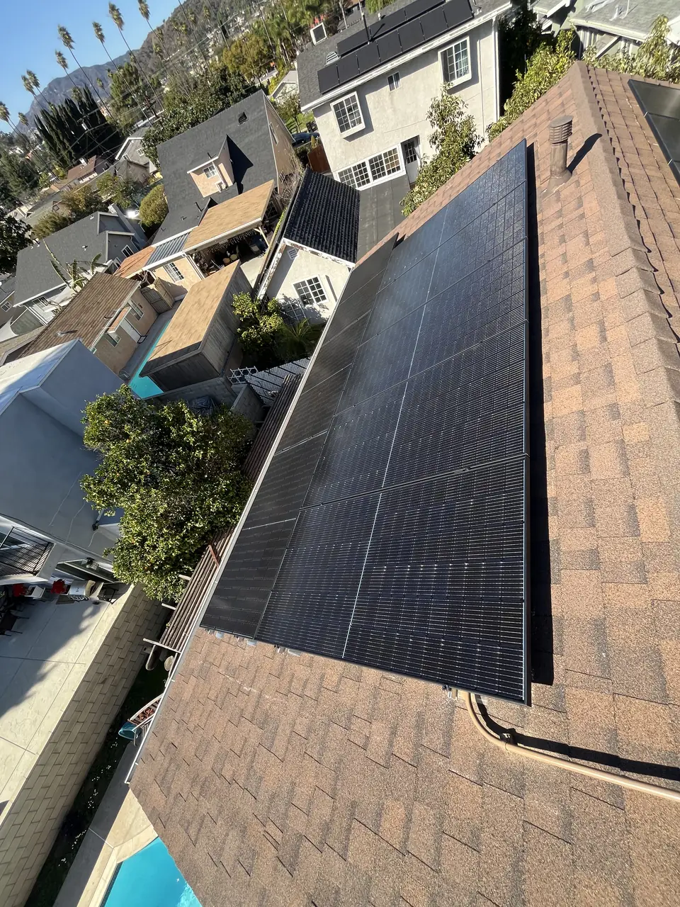 Solar panel mounting detail on a composition shingle roof in Los Angeles, CA