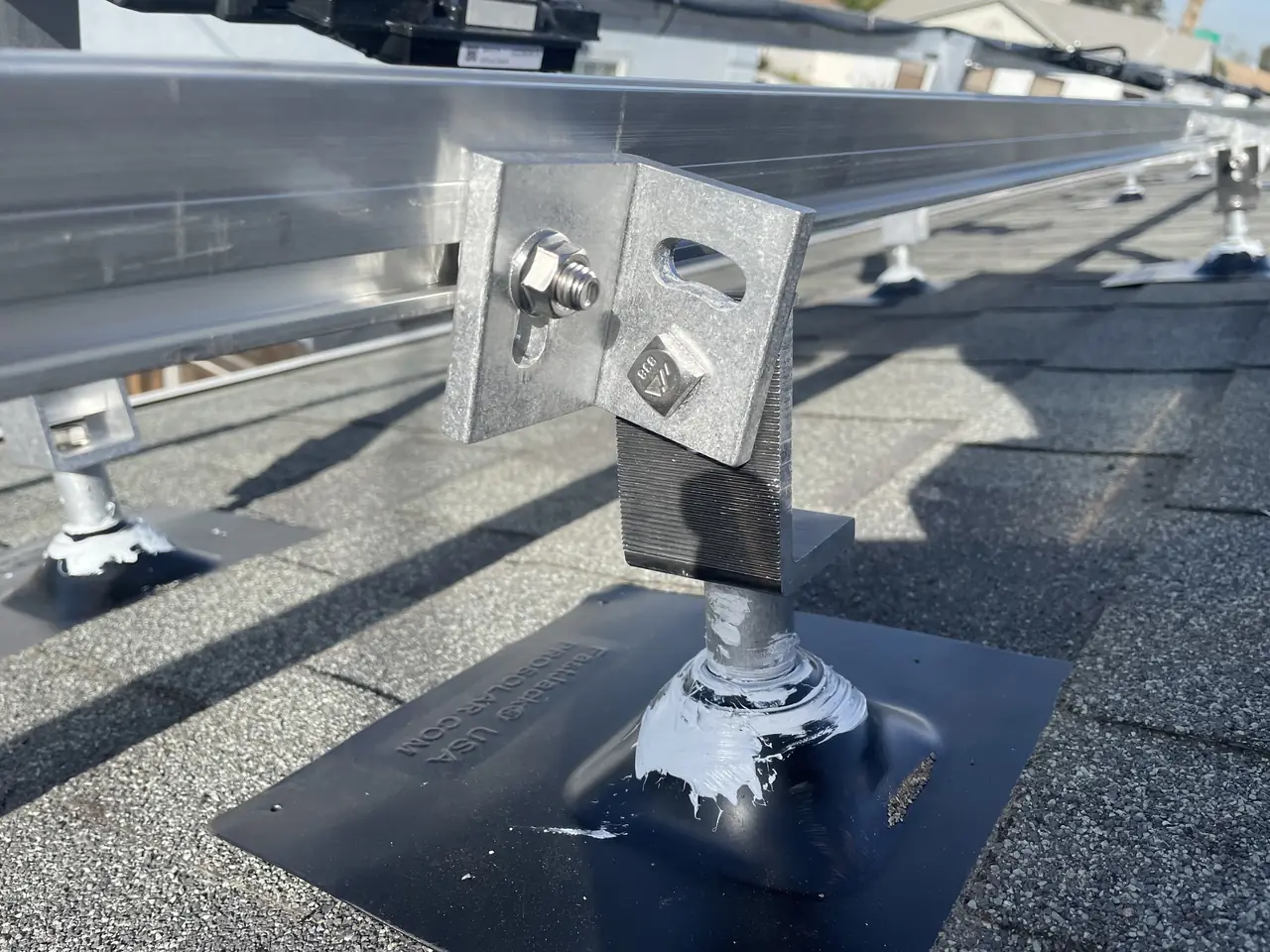 Solar panel mounting detail on a composition shingle roof in Los Angeles, CA