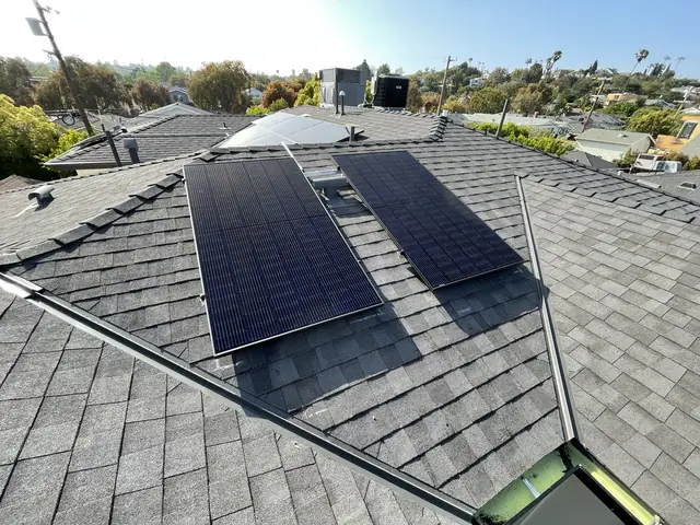 Solar panel mounting detail on a composition shingle roof in Los Angeles, CA