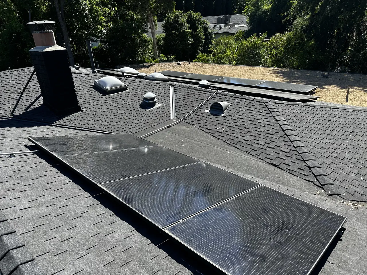 Solar panel mounting detail on a composition shingle roof in Los Angeles, CA