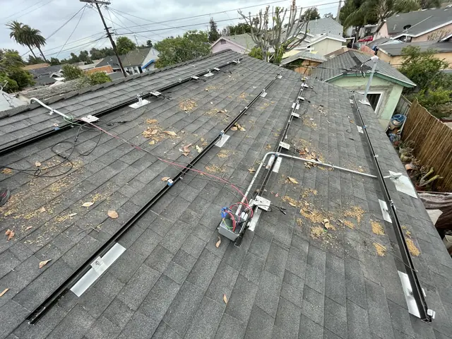 Solar panel mounting detail on a composition shingle roof in Los Angeles, CA