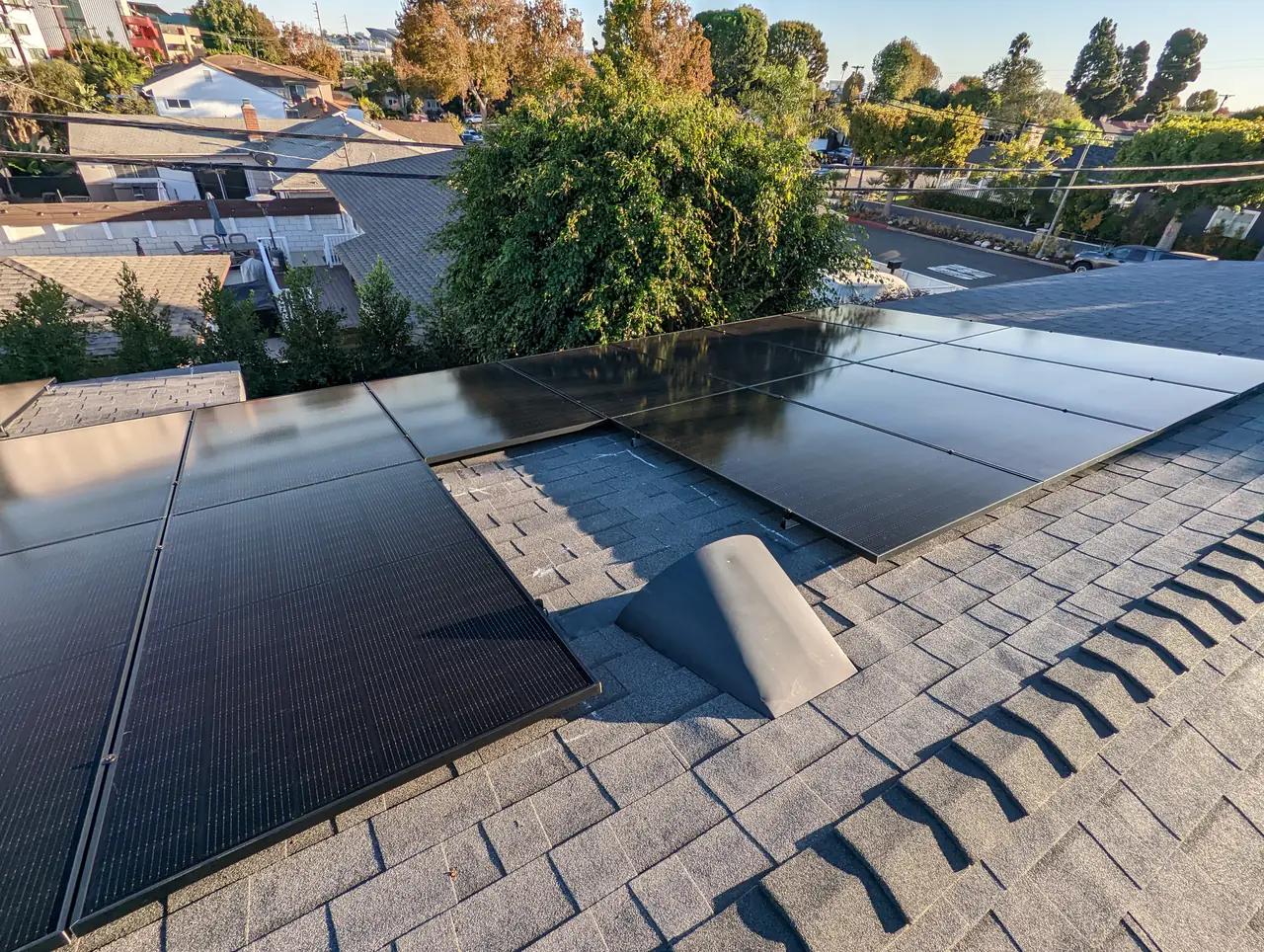 Solar modules laid across two planes of a composition shingle roof, Westchester, Los Angeles