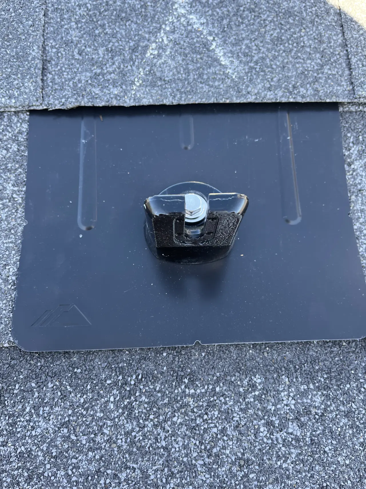 A flashed mounting foot set into a composition shingle roof, Westchester, Los Angeles