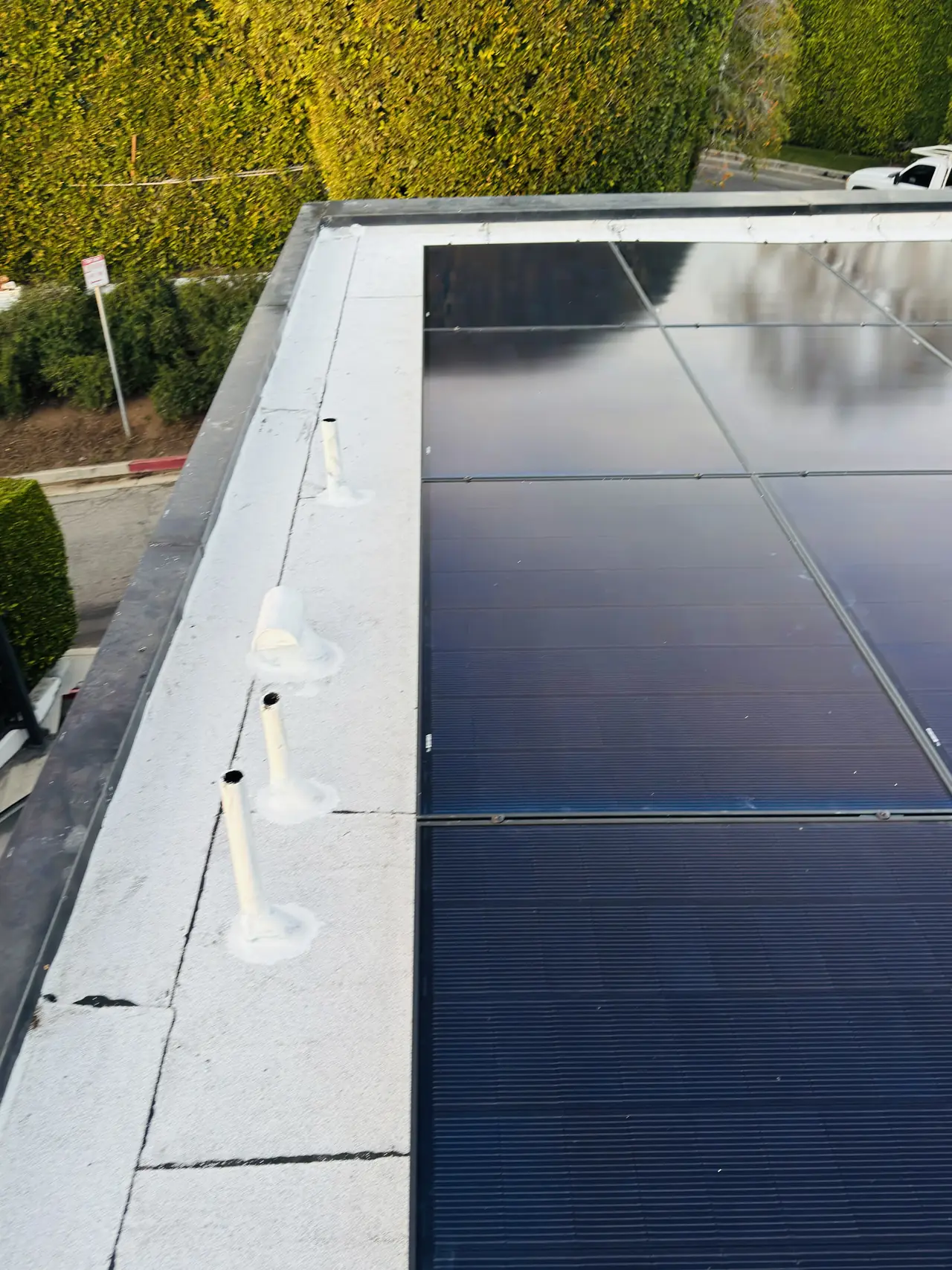 Solar modules laid out across a white low-slope roof, Brentwood, Los Angeles
