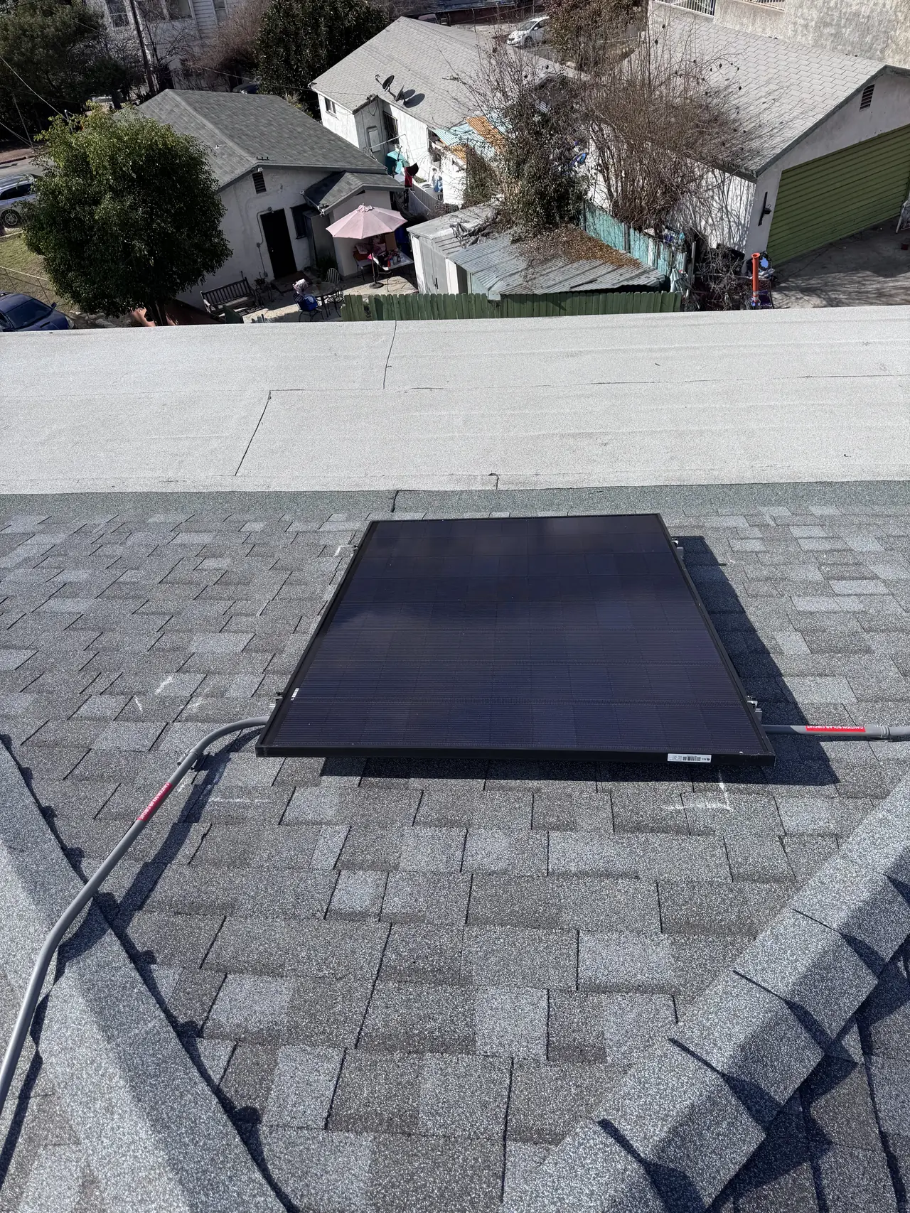 A solar module set on a composition shingle roof plane, Glassell Park, Los Angeles