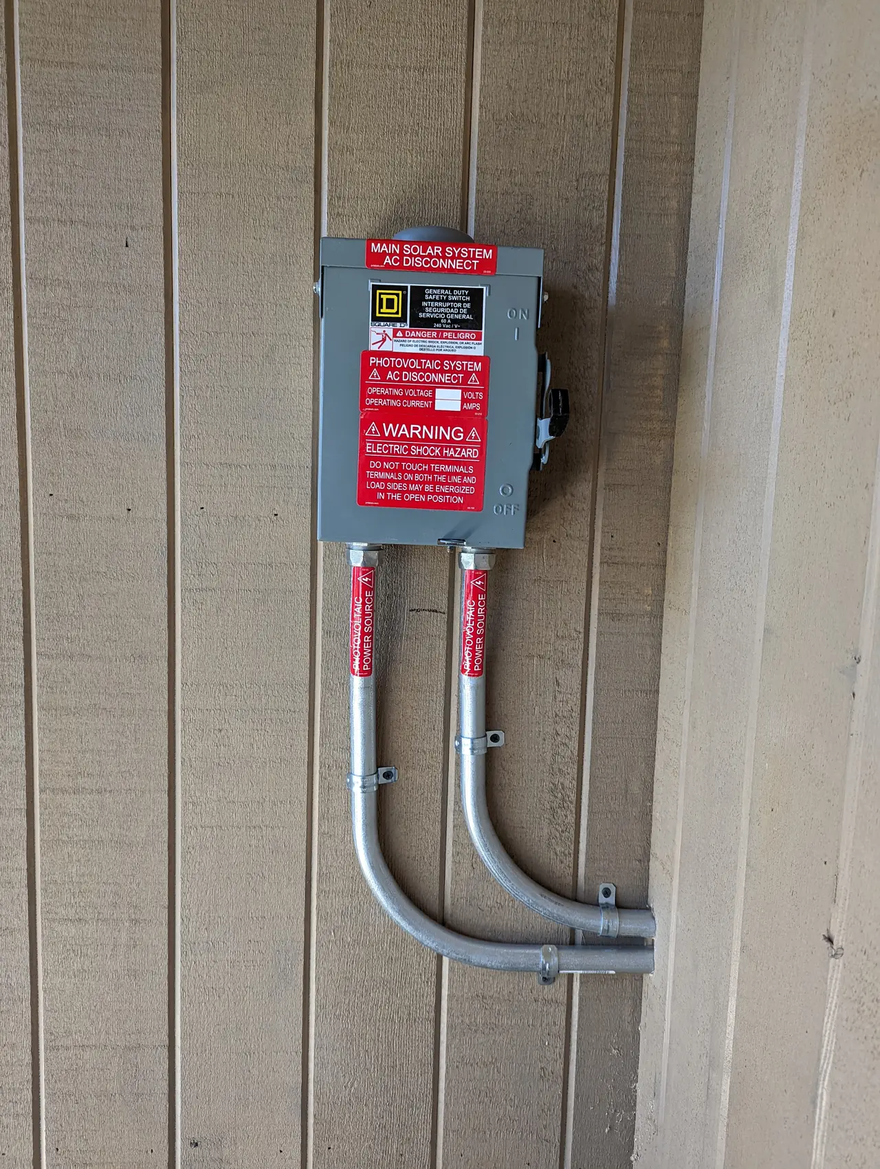 An alternating-current disconnect mounted on a timber wall with conduit entering from below, Hollywood Hills, Los Angeles