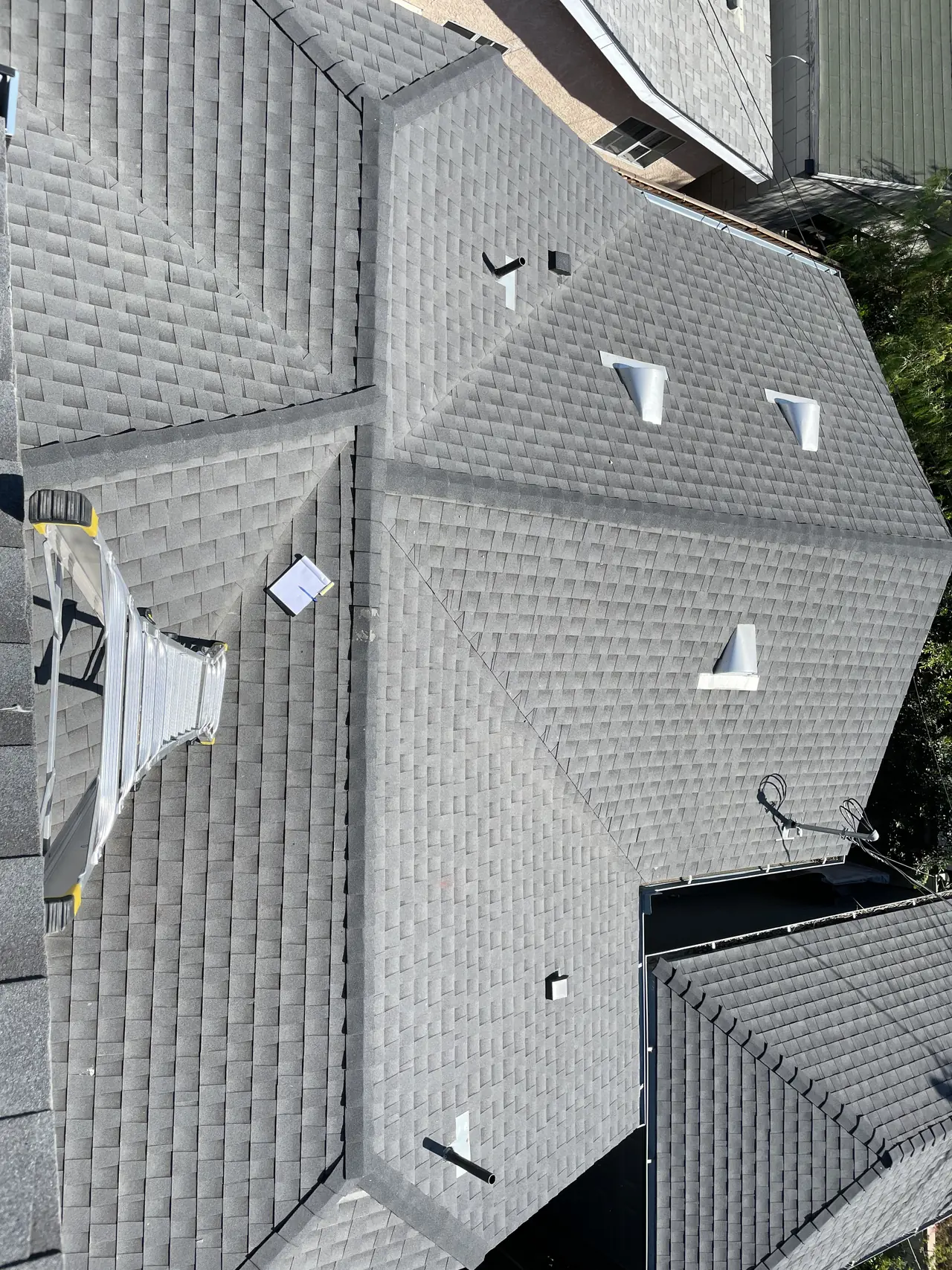 A composition shingle roof with mounting feet set out across the planes, Lincoln Heights, Los Angeles