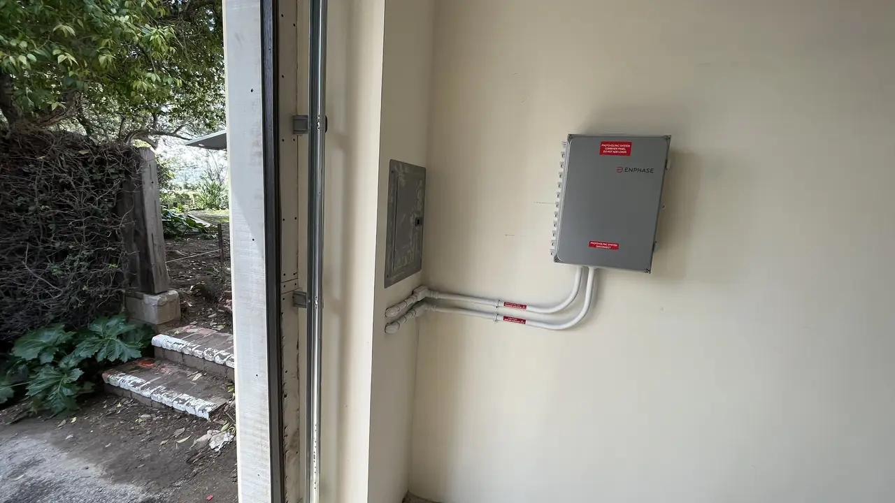 A conduit run climbing an exterior wall to a closed enclosure, Hollywood Hills, Los Angeles