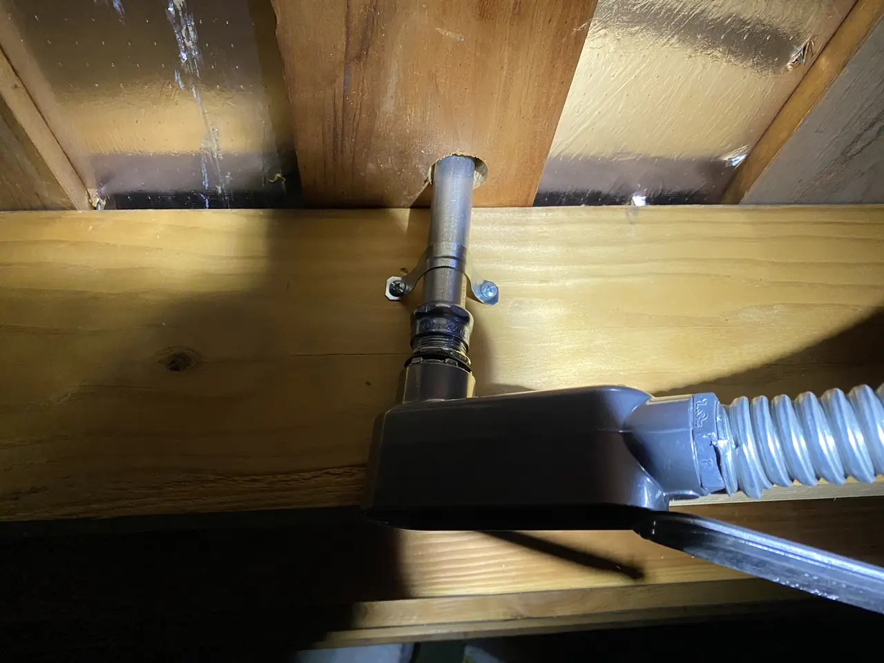 Flexible conduit passing through roof framing in an attic space, Hollywood Hills, Los Angeles