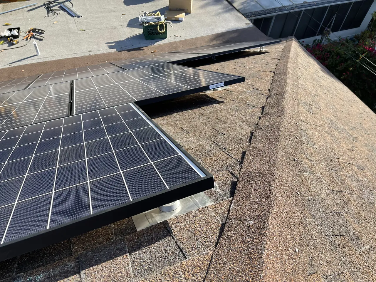 Solar modules set close to the ridge of a composition shingle roof, Echo Park, Los Angeles