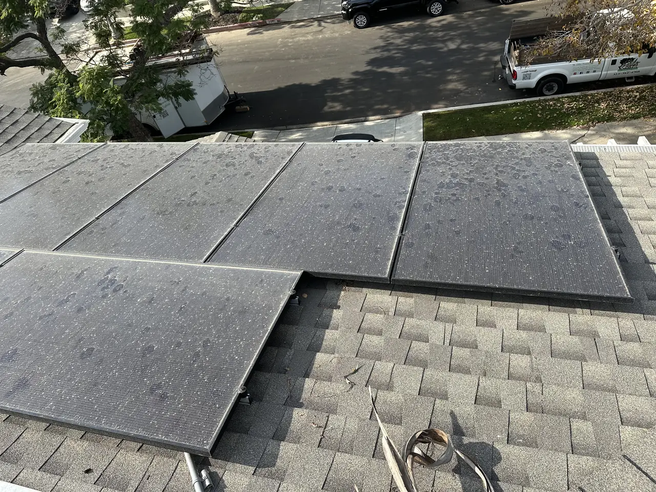 A close view of solar modules meeting the shingle course on a residential roof, Palms, Los Angeles