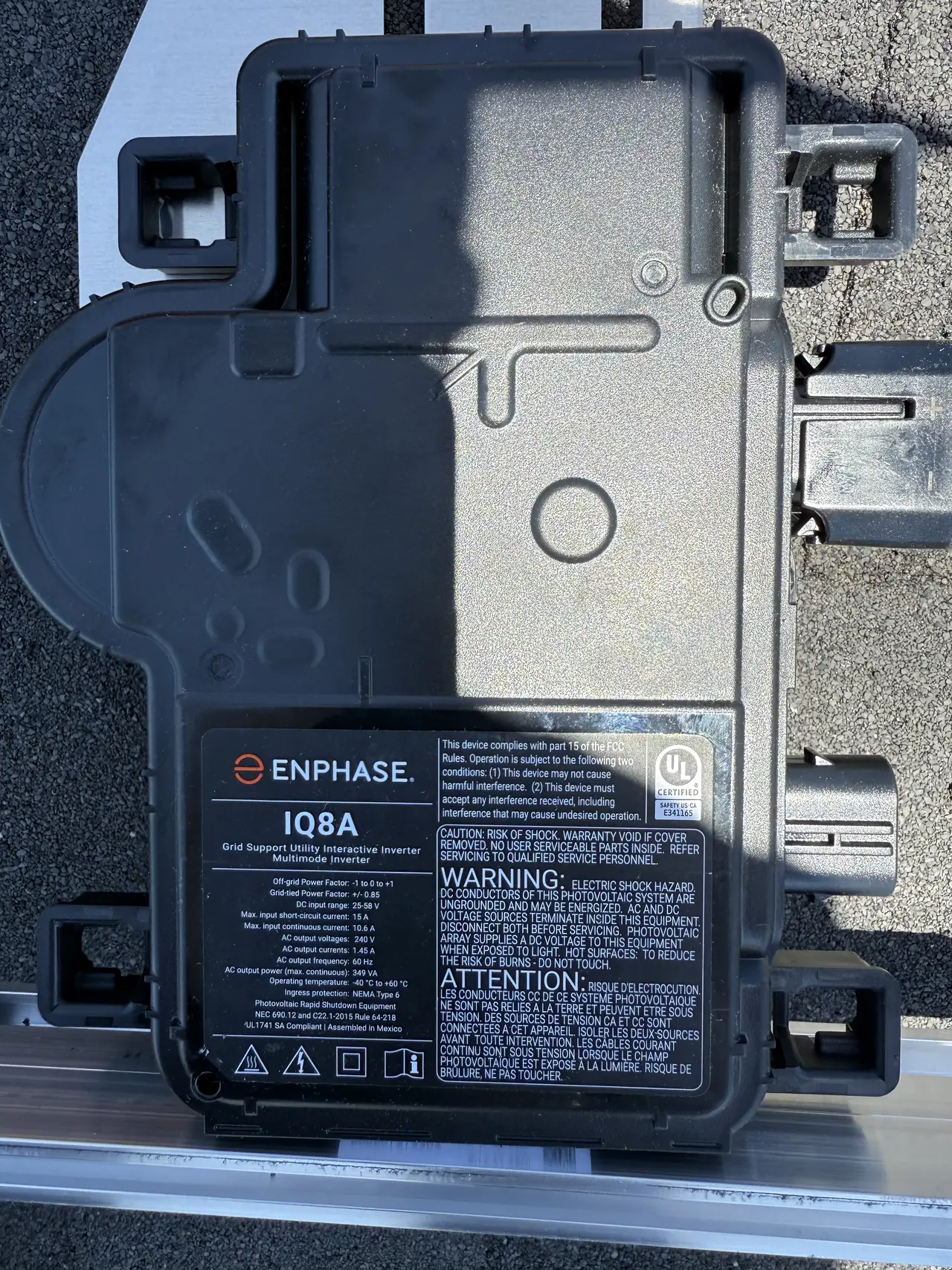An Enphase IQ8A microinverter mounted on an aluminum rail over a shingle roof, Mission Hills