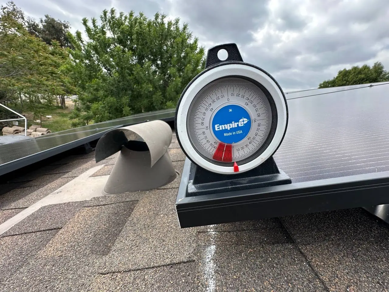 A magnetic angle finder standing on the installed framing beside a roof vent, measuring the slope, North Hills, Los Angeles