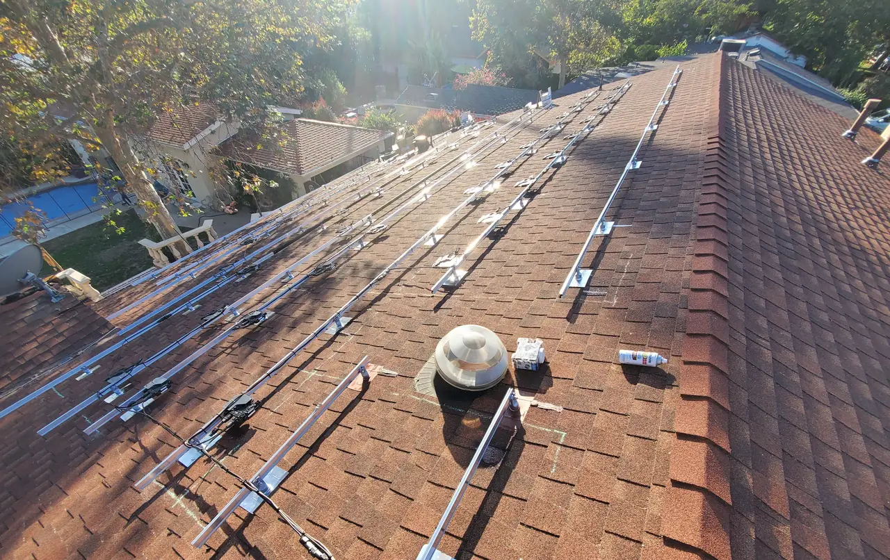 Long rail runs climbing a shingle roof plane toward the ridge, North Hollywood