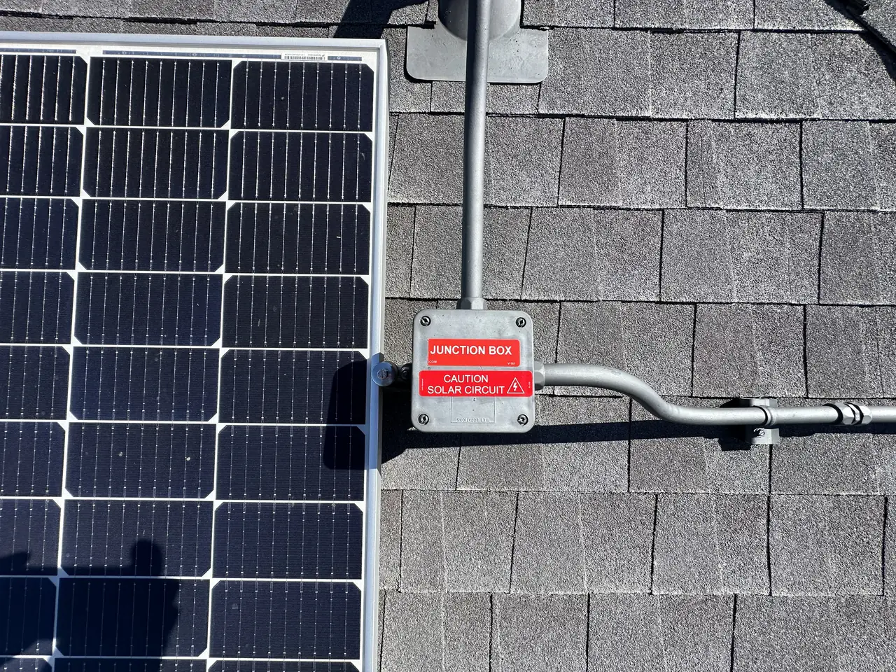 Module edge and roof junction box on new composition shingle, North Hollywood