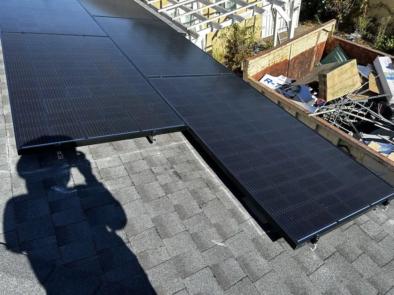 Two solar arrays meeting at right angles over a roof hip, North Hollywood