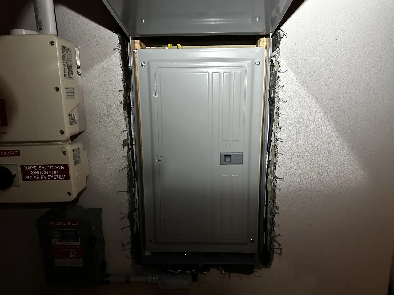 An electrical panel set into an exterior wall with solar equipment beside it, North Hollywood