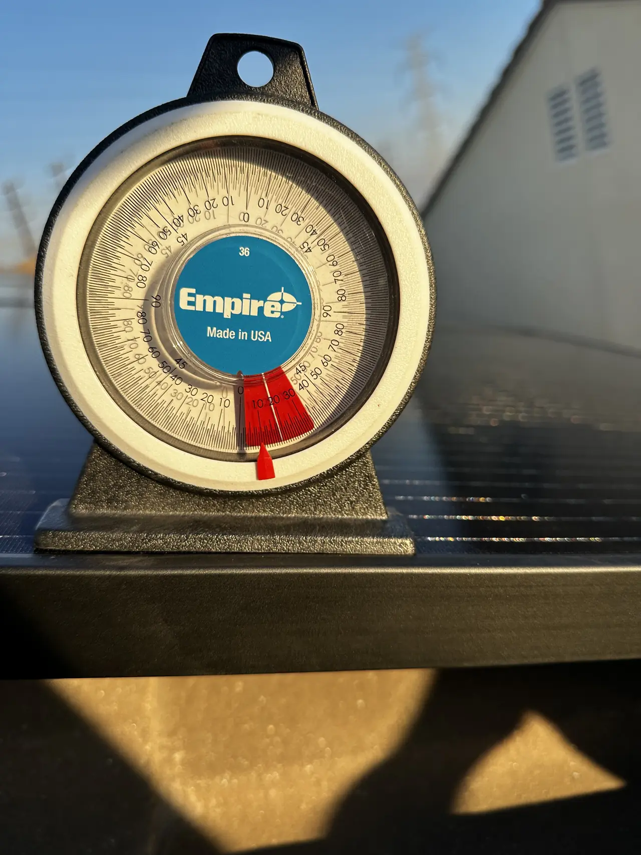 An angle finder standing on an installed solar module on a tile roof, North Hollywood
