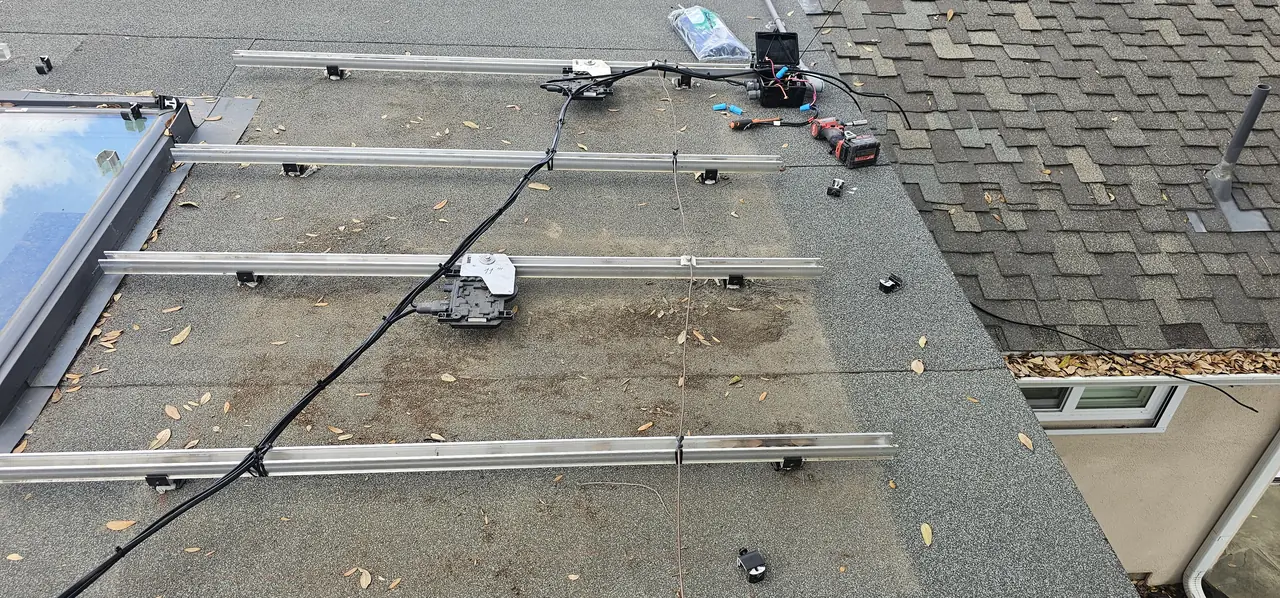 Rails and conduit runs across a roof above an existing array, Northridge
