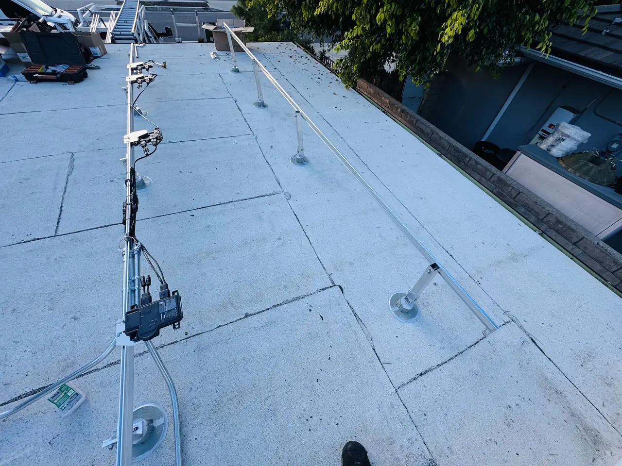 Rails, mounts and wiring across a coated flat roof, Northridge