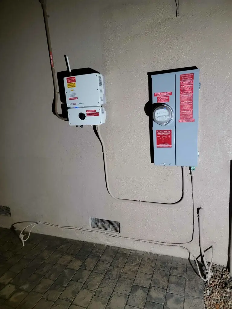 String inverter and AC disconnect mounted on an exterior wall, Northridge