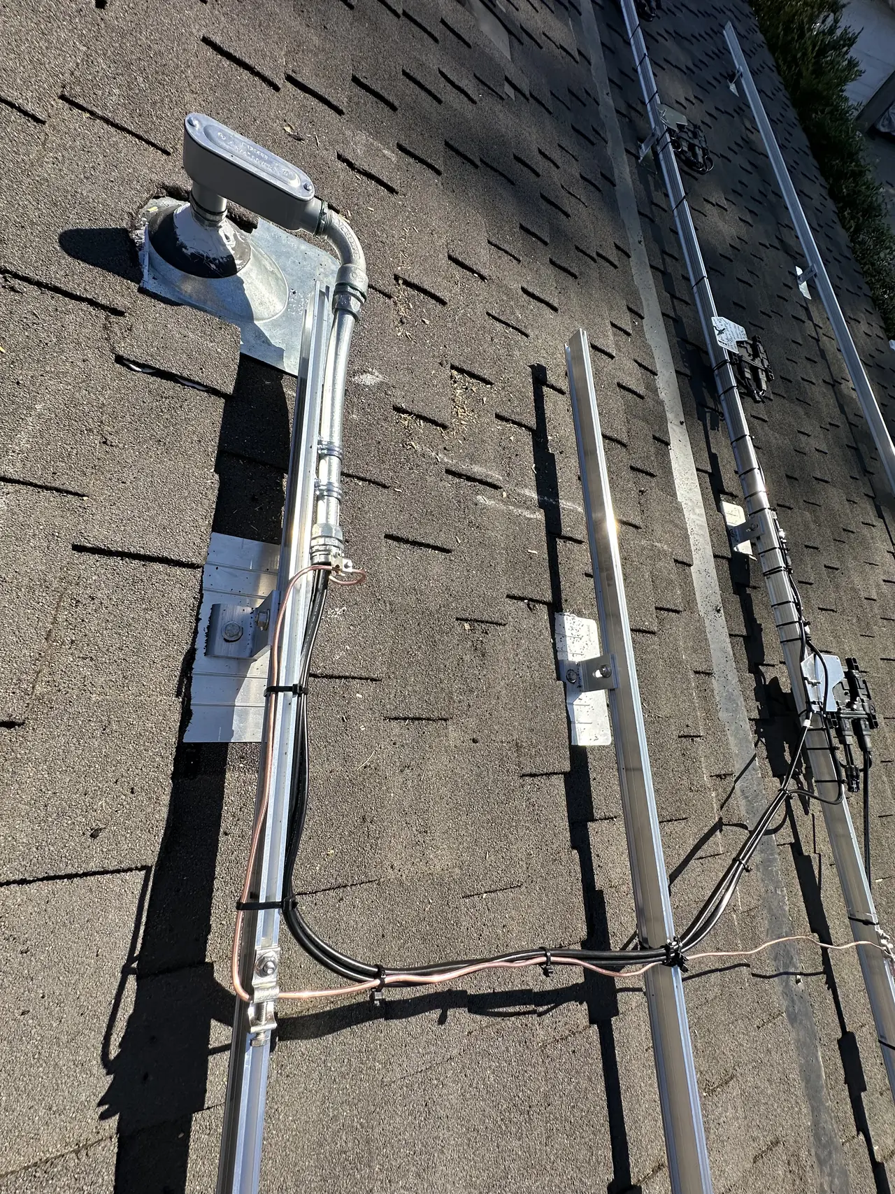 A plumbing vent and mounting rails on a composition shingle roof, Northridge