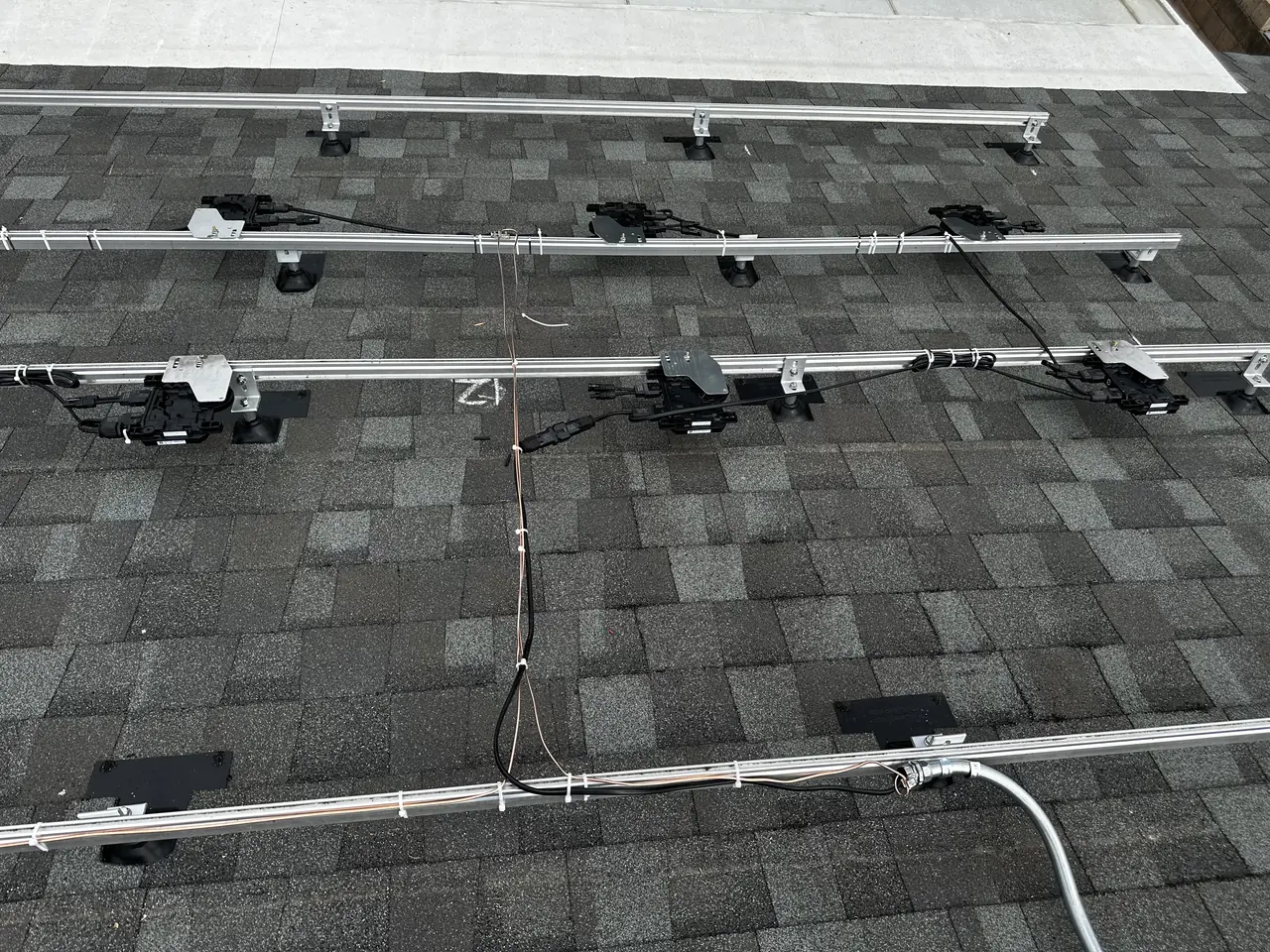 Microinverters mounted along the rail under the modules, Northridge