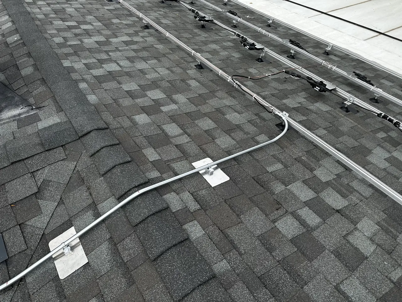 Conduit and mounts running across a shingle roof, Northridge