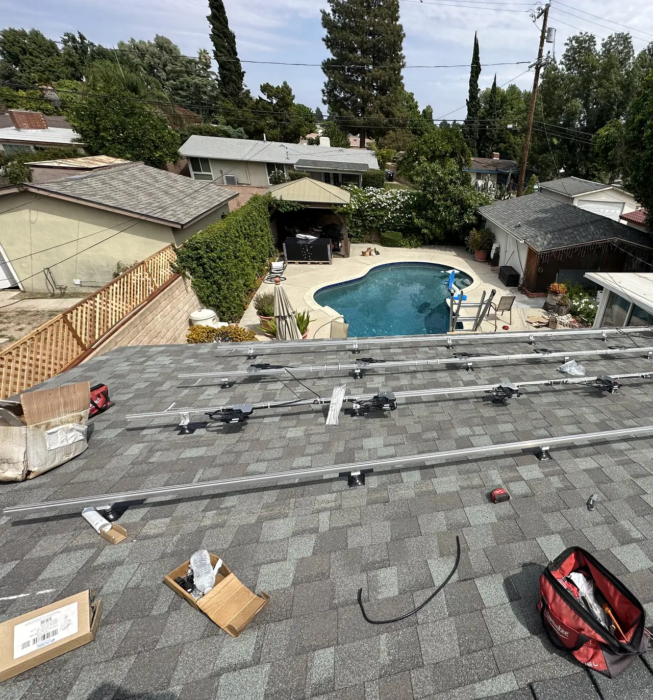 Rails and microinverters laid out on a shingle roof, Northridge