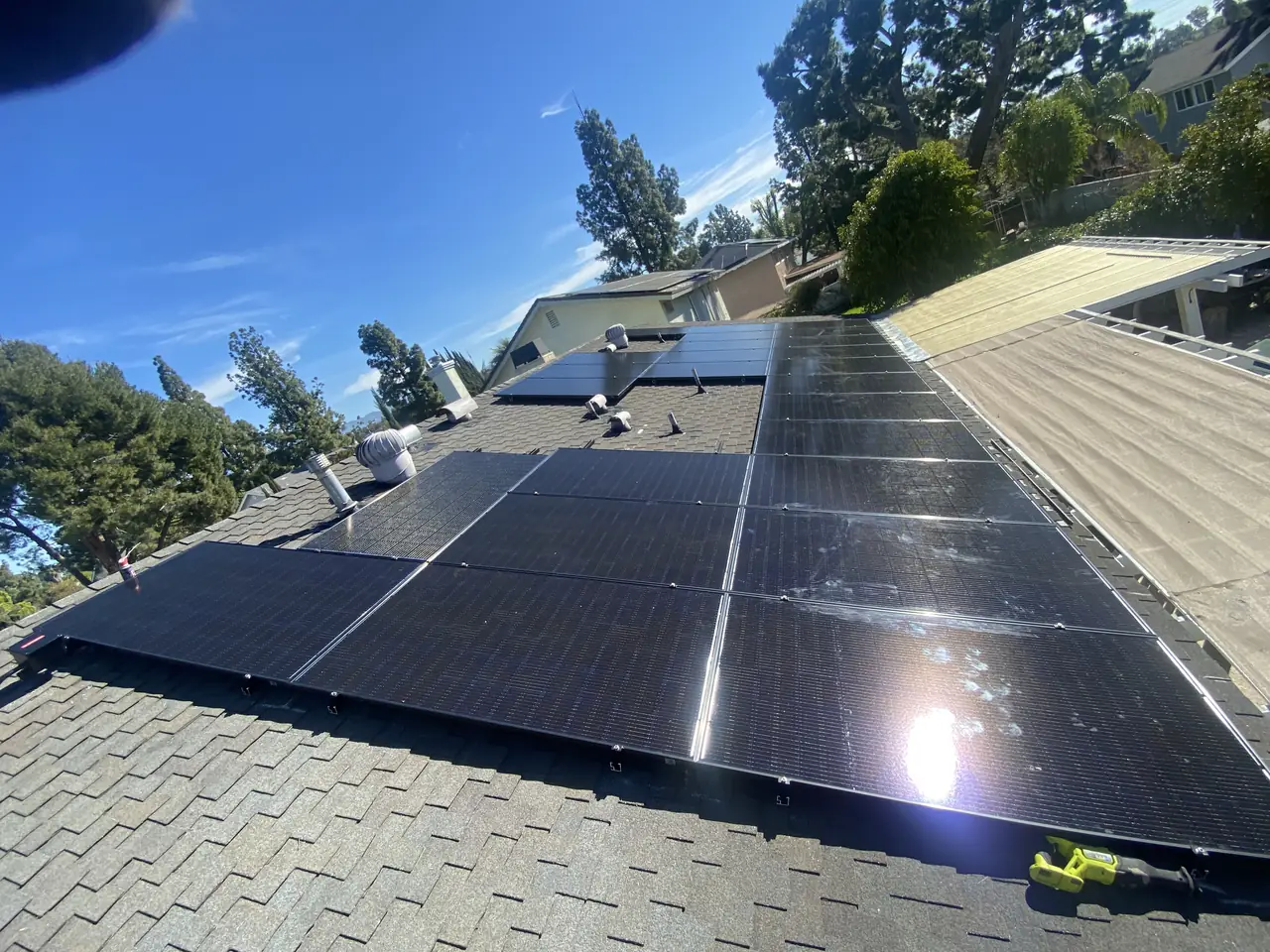 Solar modules installed on a shingle slope under a clear sky, Northridge