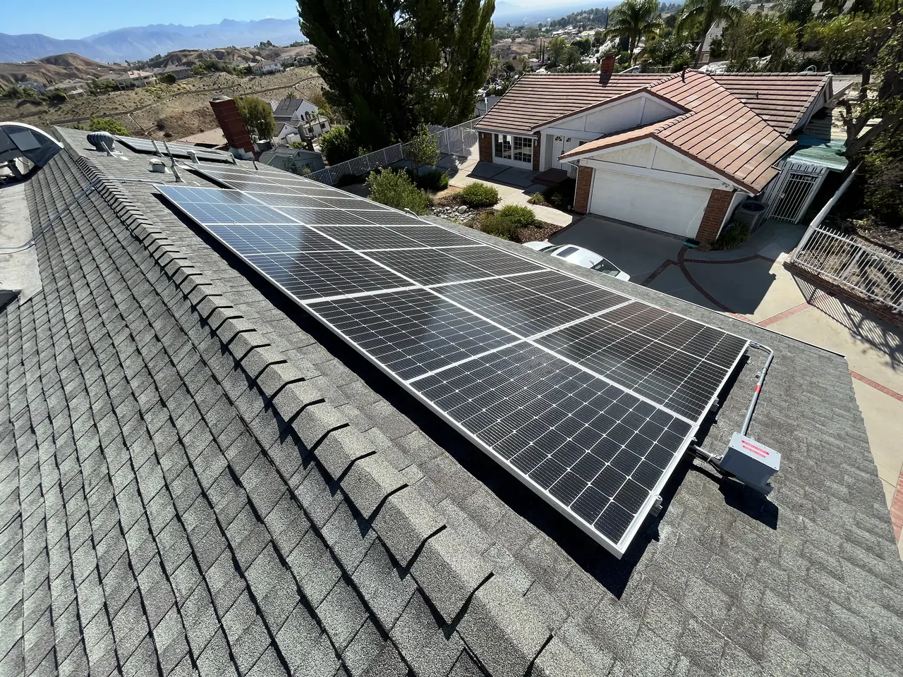 Solar modules running down a shingle slope toward the hills, Northridge