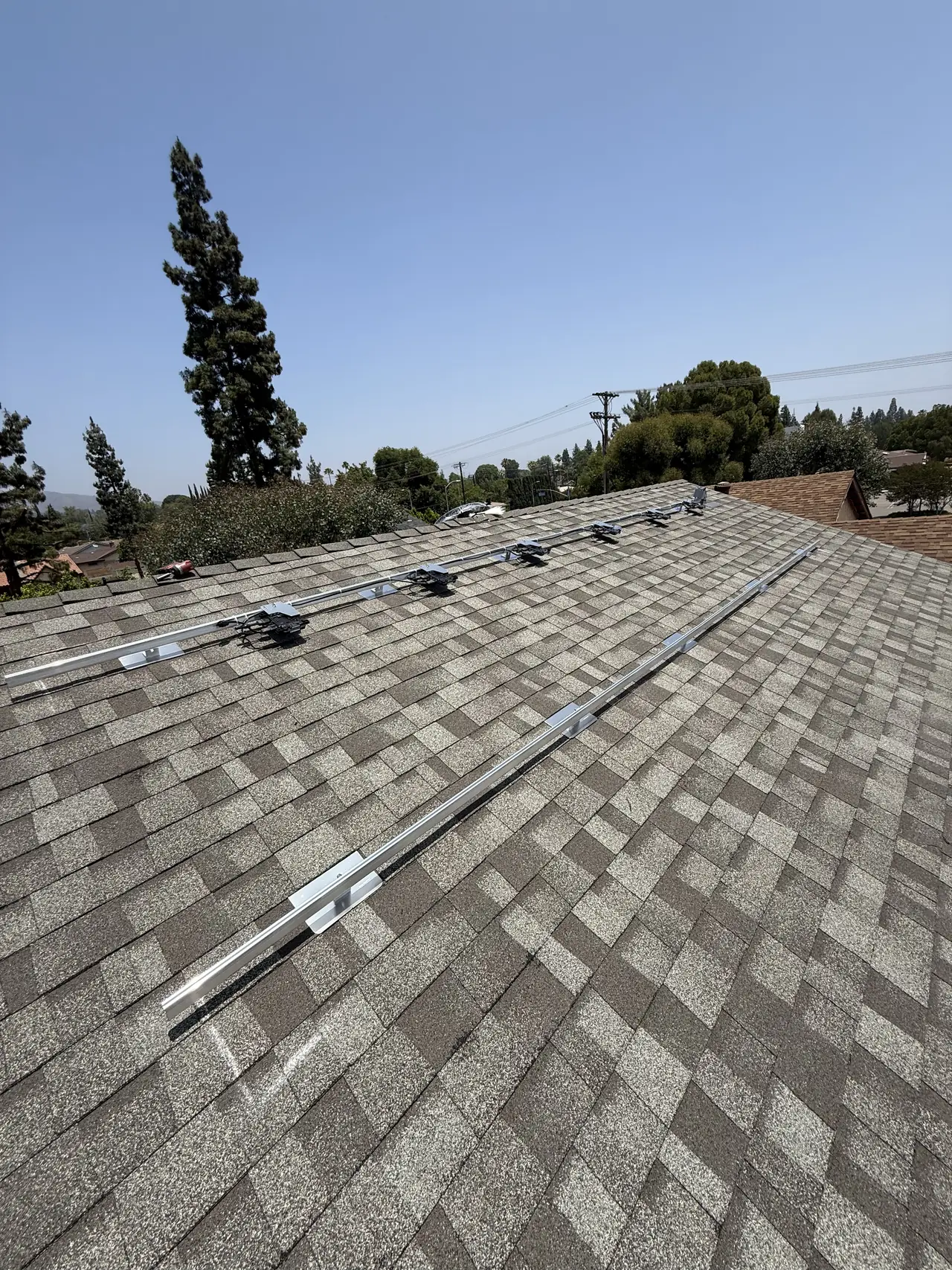 Mounting rails across the shingle roof of a new building, Northridge