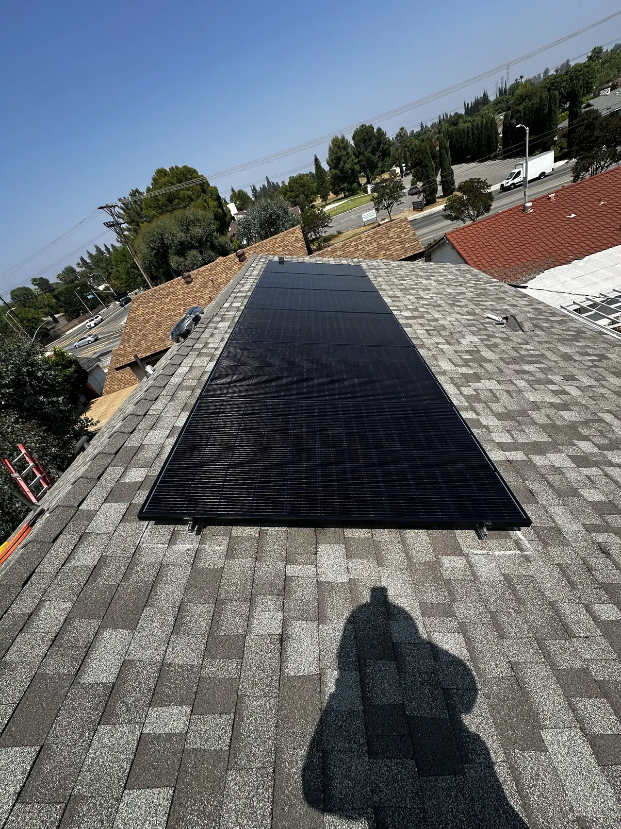 Finished solar array seen along the ridge of a new hip roof, Northridge