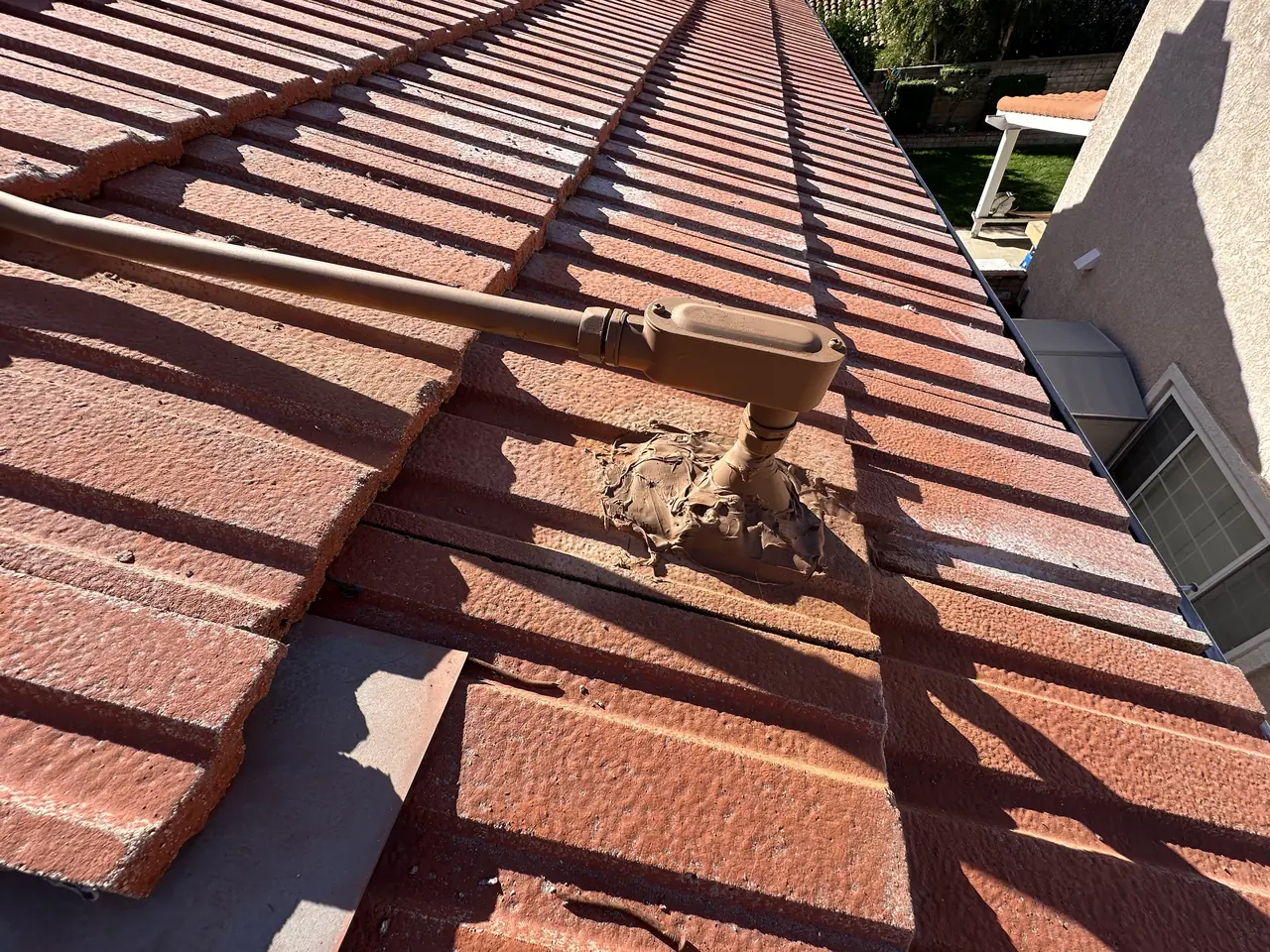 Barrel tile lifted to expose battens and a mounting anchor, Northridge