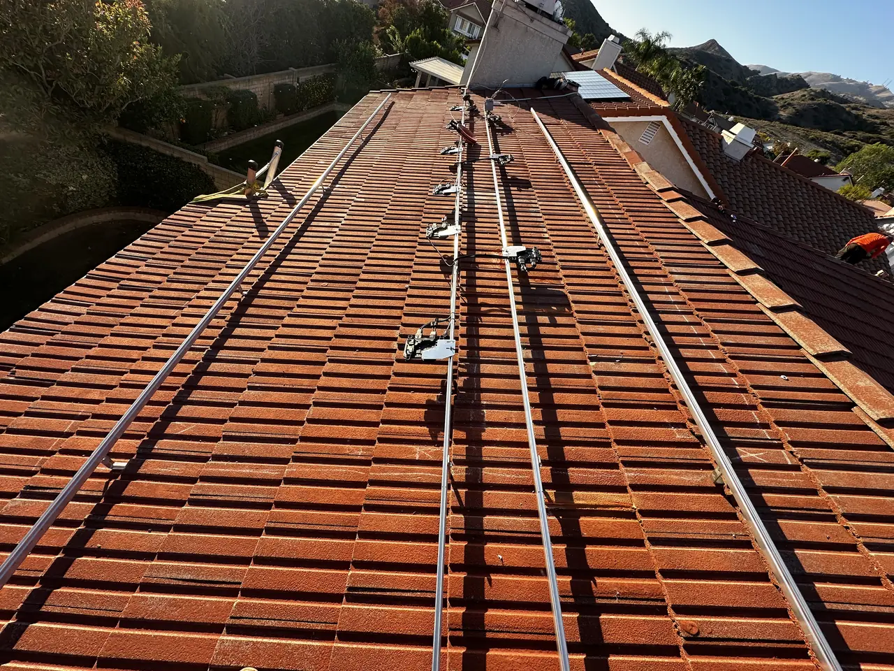 Rails running across a red barrel tile roof, Northridge