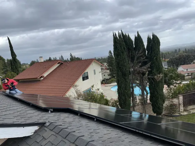 Solar array along a shingle roof under heavy cloud, Northridge